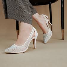 Elegant white heels paired with a modern outfit